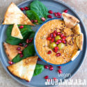 overhead view of muhammara in a bowl with pita chips