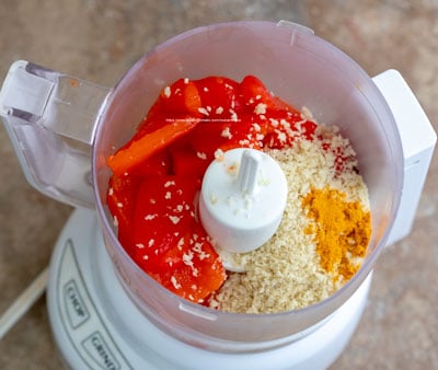 overhead view of turmeric in food processor - Muhammara