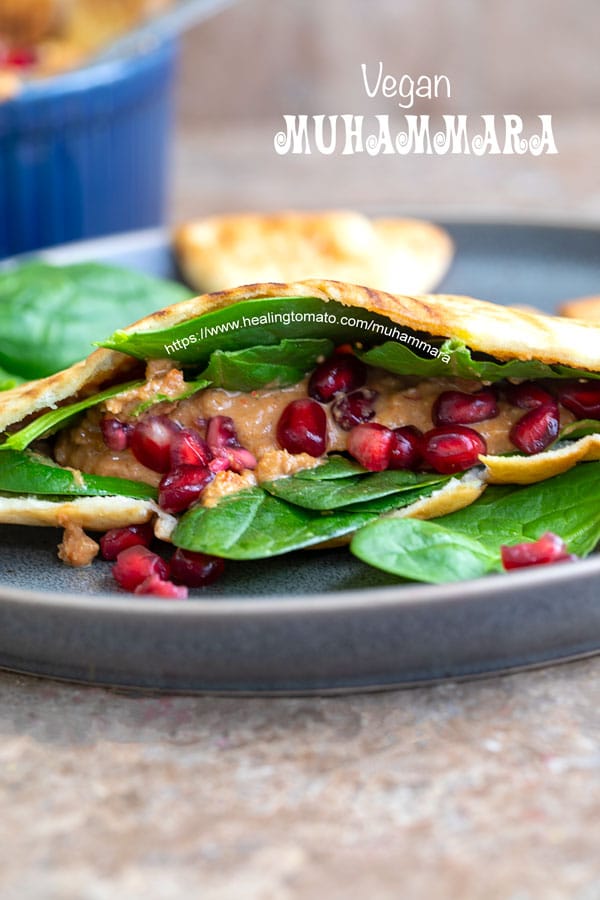 Front view of pita sandwich filled with spinach and muhammara