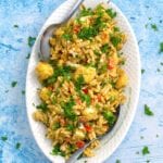 Overhead view of roasted cauliflower salad on a white oval serving platter - 5 Hearty Vegan Recipes in Dutch Oven