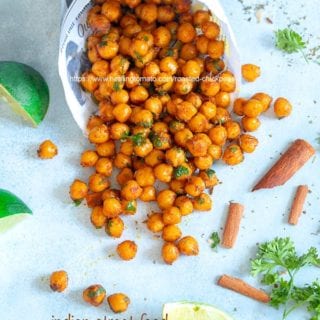 Overhead view of newspaper shaped in a cone laying flat with roasted chickpeas falling out of it