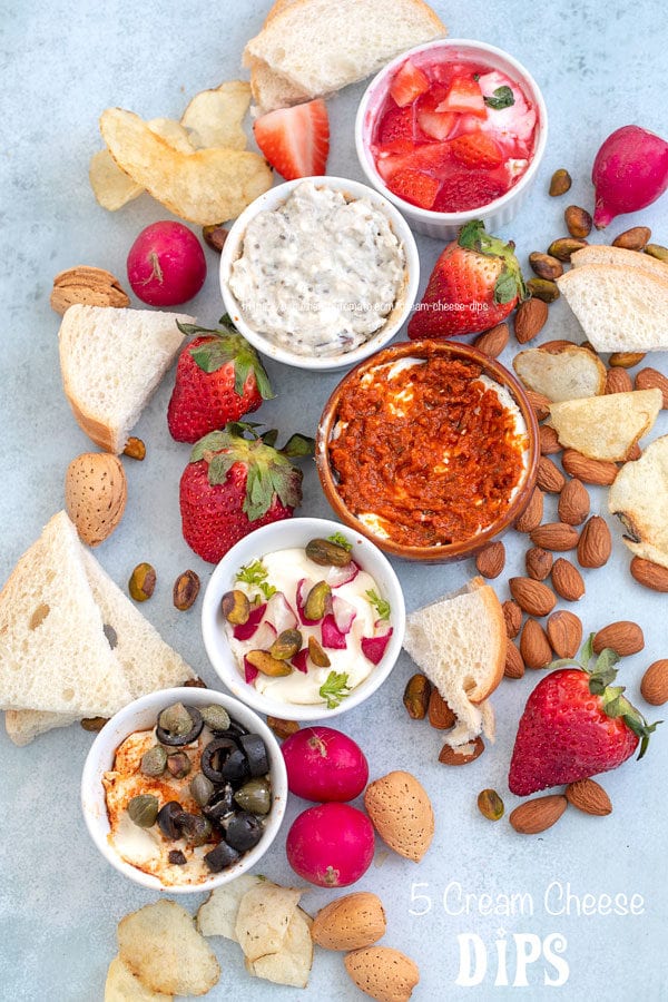 Top view of all 5 cream cheese dips surrounded by fruits, veggies and nuts