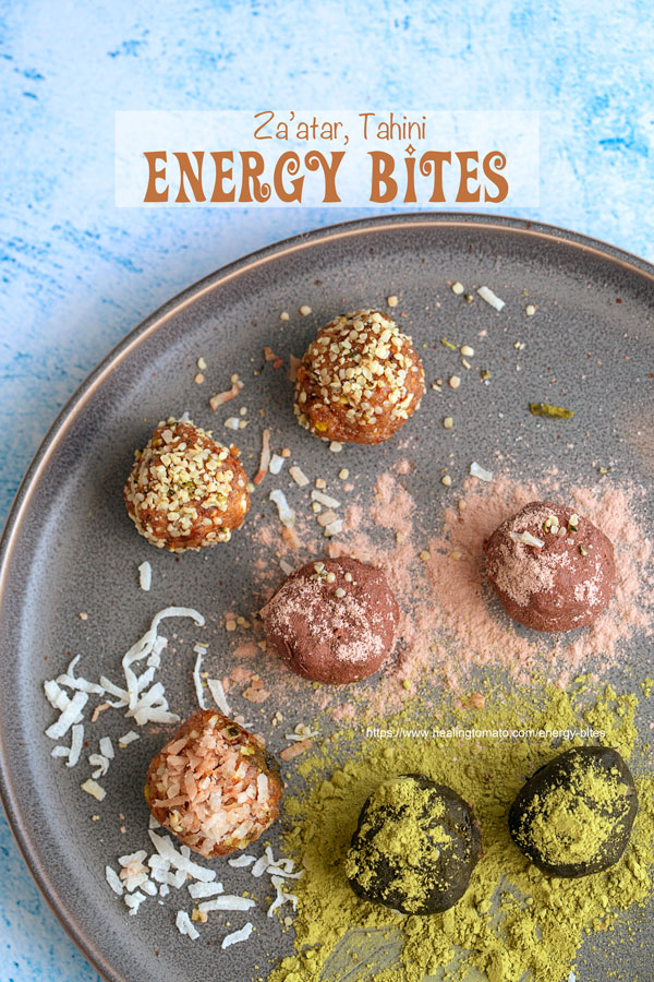 Overhead view of 7 protein bites on a dark grey plate