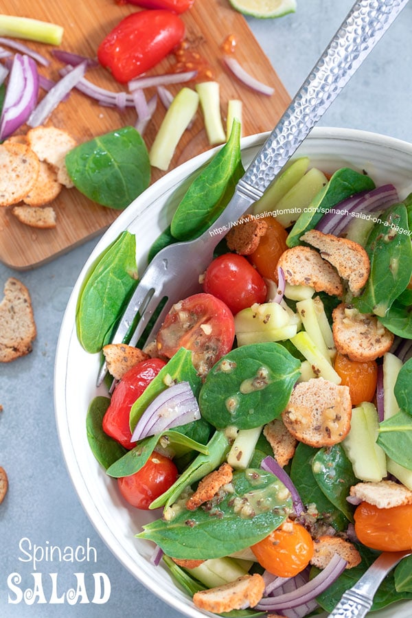 Overhead view from the top of spinach salad bowl with dressing