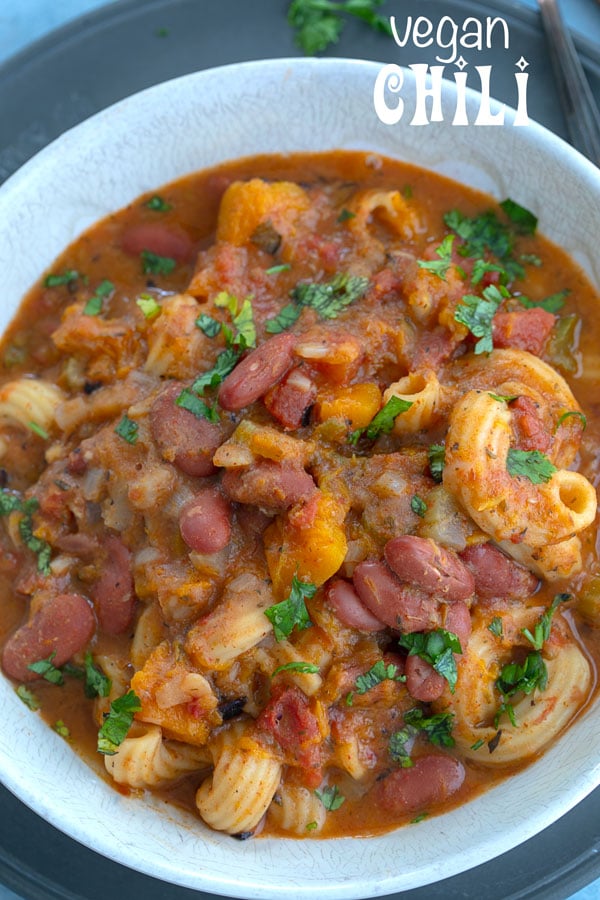 Overhead and closeup view of vegan chili recipe in a white bowl