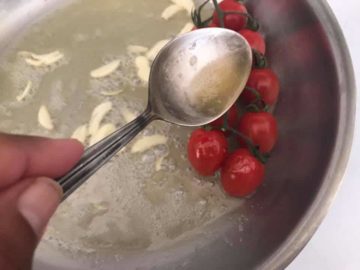 butter being poured on cherry tomatoes