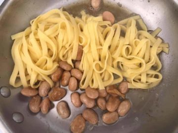 Fettuccine pasta added to pan with butter beans