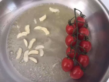 1 branch of cherry tomatoes added to a pan with butter and garlic