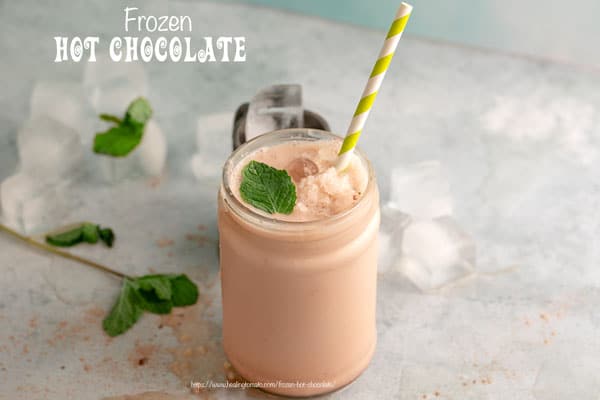 Front View of Frozen Chocolate Drink in a tall glass bottle with mint on the side