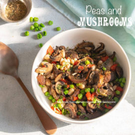 Top view of a white bowl filled with peas and mushrooms.