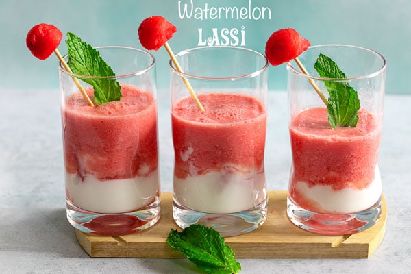 Front view of 3 small glasses filled with watermelon lassi and a yogurt layer at the bottom