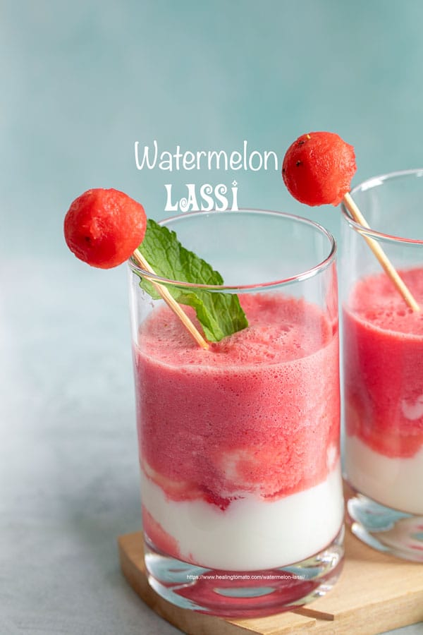 Front view of 1 small glasses filled with watermelon lassi and a yogurt layer at the bottom