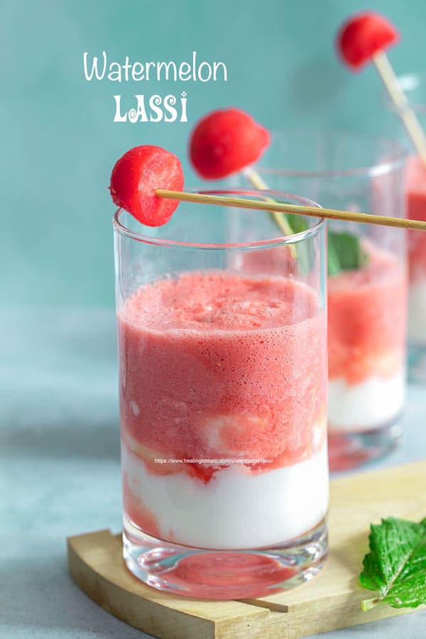 Front view of 1 small glass filled with watermelon sweet lassi and a yogurt layer at the bottom