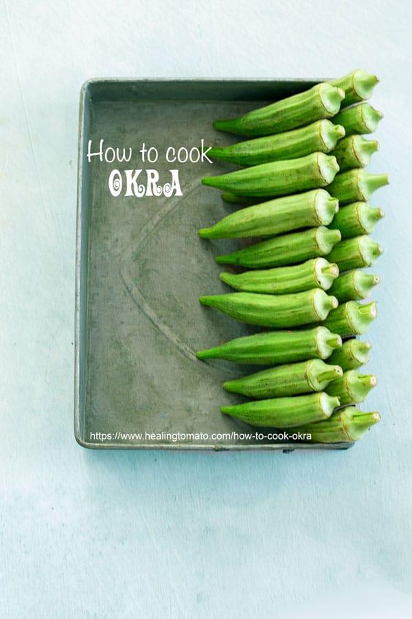 Top view of 2 rows of okra lined to the right on a grey tray