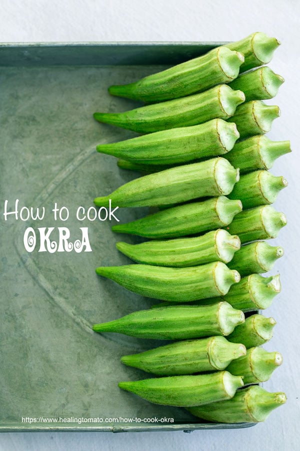 Top view of 2 rows of okra lined to the right on a grey tray