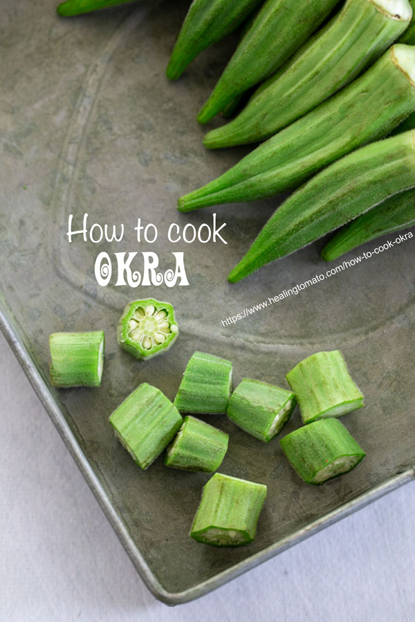 Okra cut into thick rounds on a metallic tray
