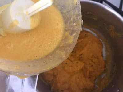 food processor ingredients being added to pan