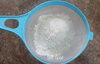 flour on a blue nylon strainer