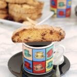 front view of a single biscotti on top of a coffee mug by Soup Addict
