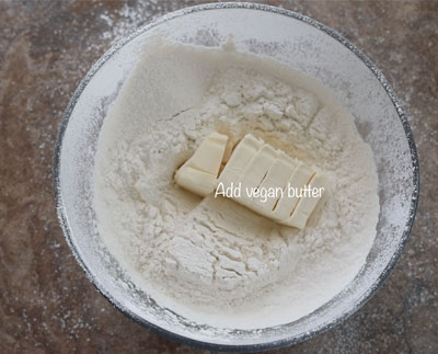 sliced butter in a sifted flour bowl