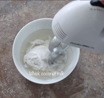 coconut milk being whisked in a bowl