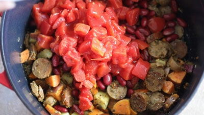 A can of diced tomatoes added to the dutch oven ingredients