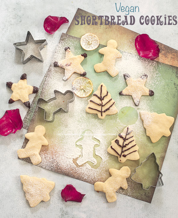 Top view of vegan shortbread cookies shapped like stars, gingerbread man and Christmas tree