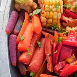 Closeup view of roasted carrots, bell pepers and corn