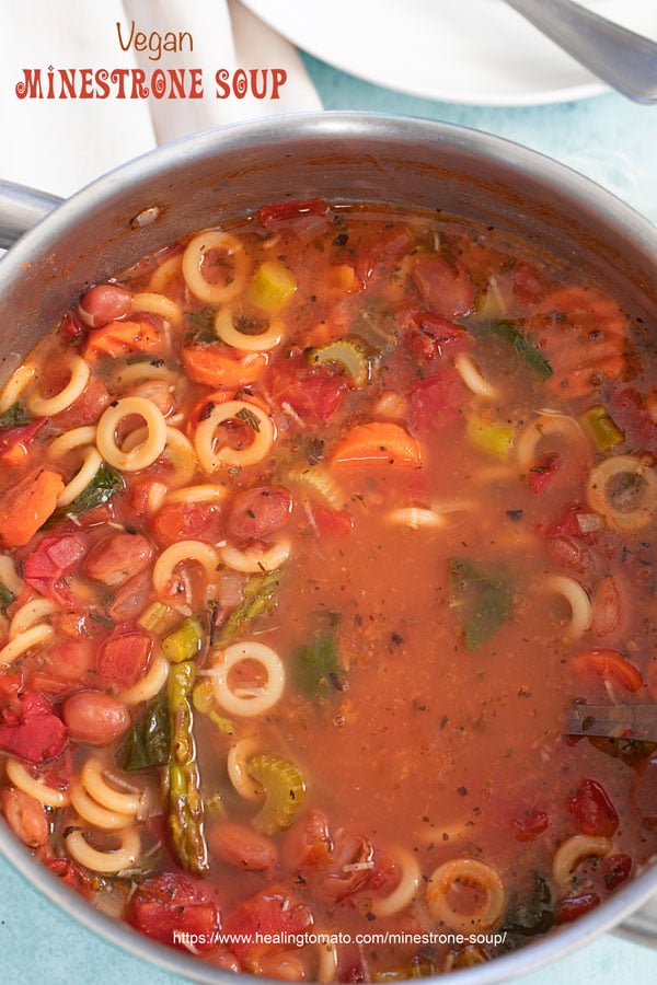 Closeup view of Minestrone soup in a stainless steel pan