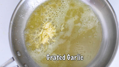 Grated garlic added to the melted vegan butter