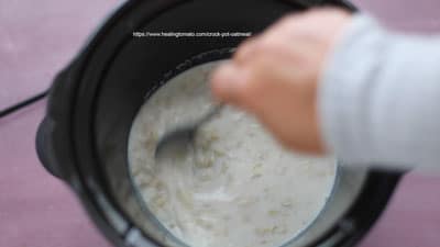 The author's hand are shown mixing the ingredients in the crock-pot