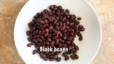 Top view of black beans in a light grey bowl