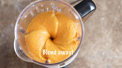Top view of the inside of the blender where the ingredients are being blended