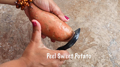 The author peeling a sweet potato