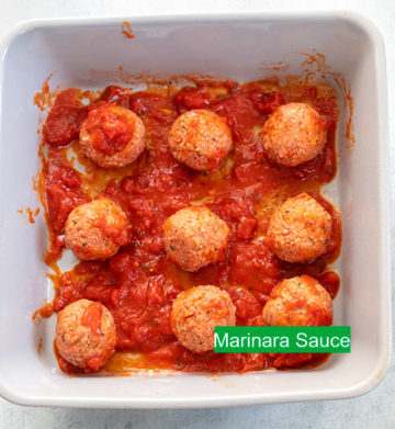 Top view of 1/4 cup of marinara sauce added to the column and rowof meatballs