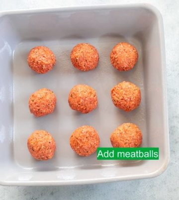 Top view of 9 plant-based meatballs arranged in a 3x3 row/column on grey baking dish