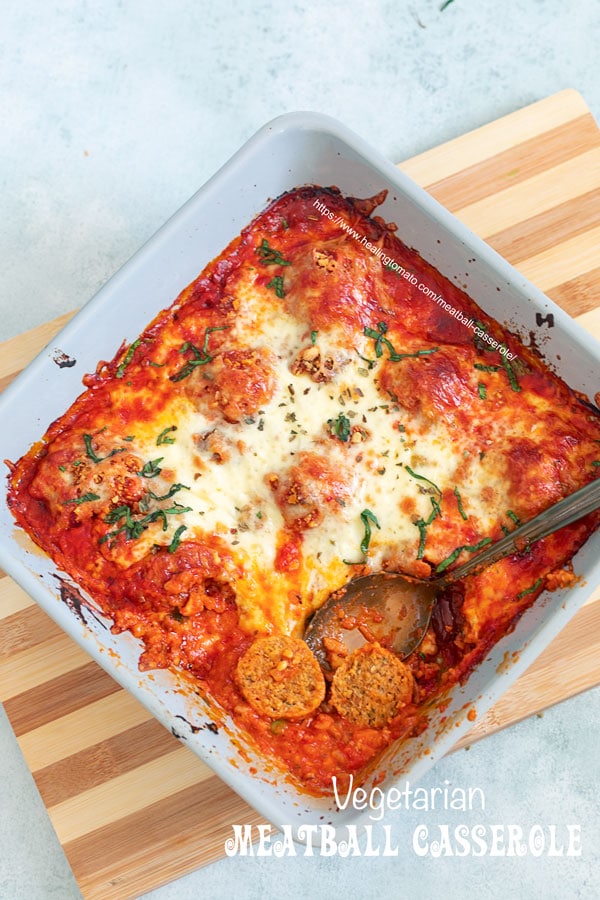Top view of the meatball casserole with one plant-based meatball cut into half to show its casserole