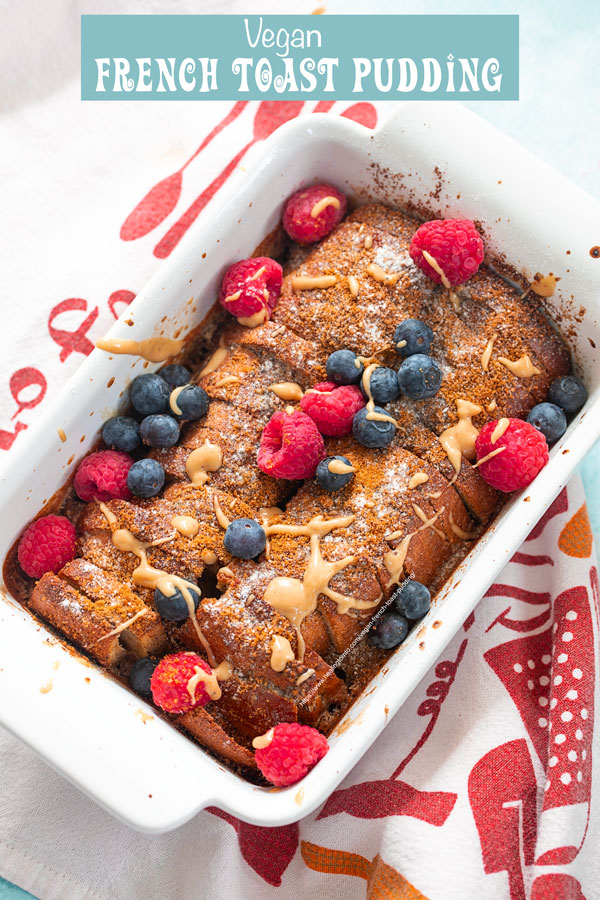 top and closeup view of vegan French toast bread pudding garnished with raspberries and blueberries with almond butter syrup lightly drizzled on top.