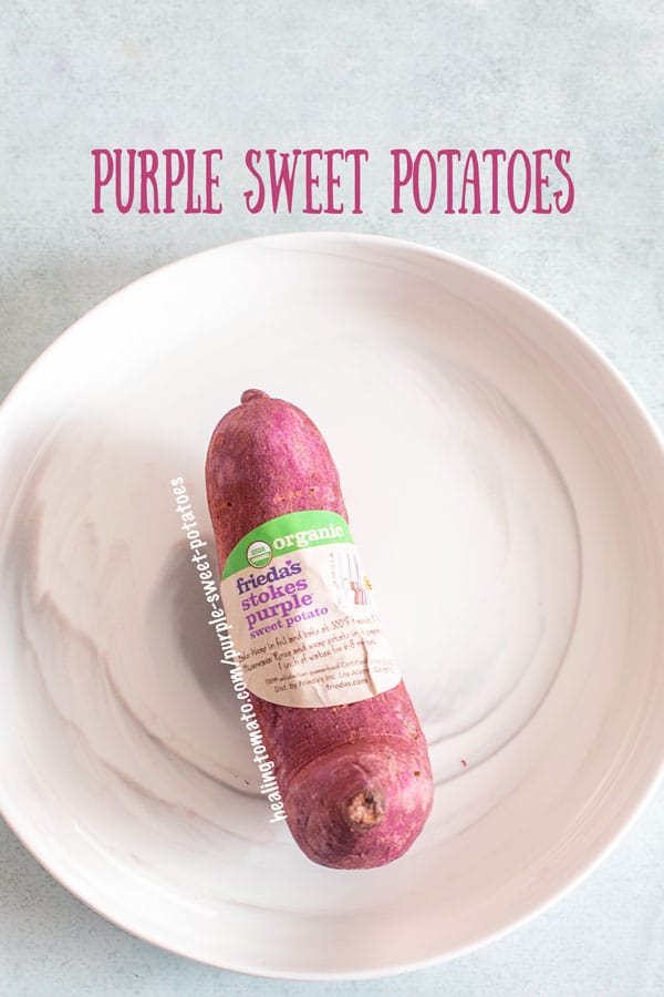 top view of an organic stokes purple sweet potato on a white plate with it's label showing