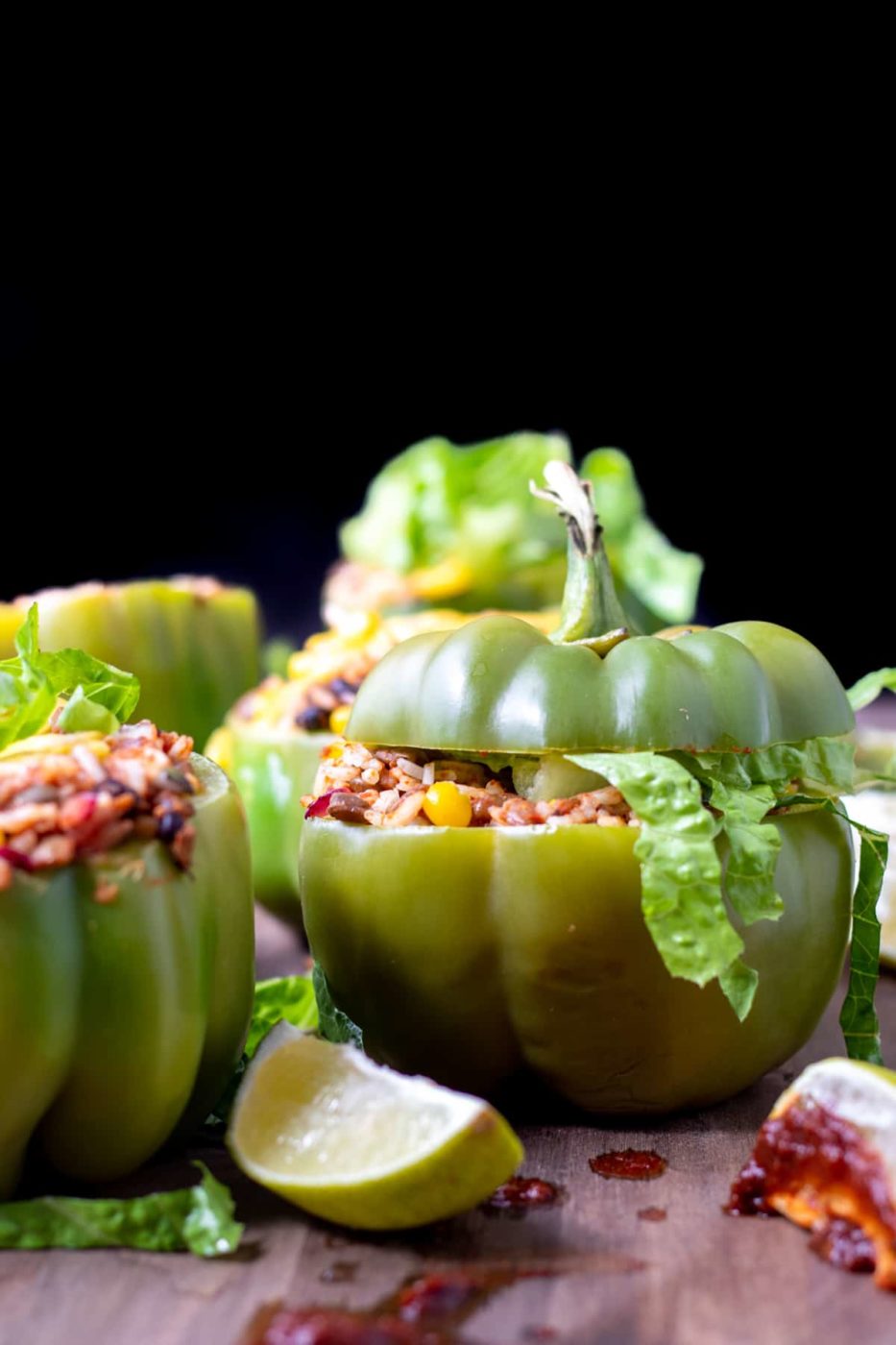 front view of green peppers stuffed with lentils and rice - By Home Cooked Roots