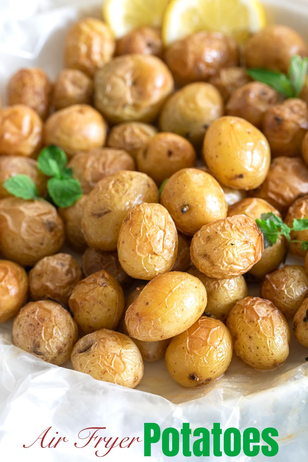 Front view of tiny potatoes in a garlic butter sauce put on a wax paper