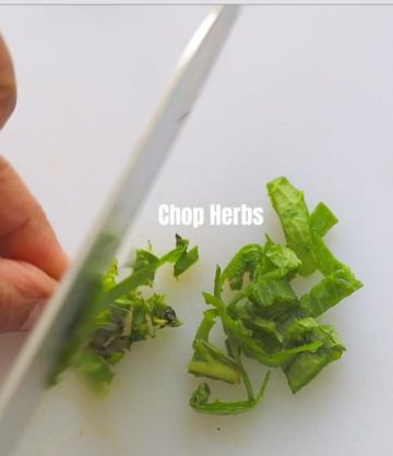 top view of the author chopping fresh herbs