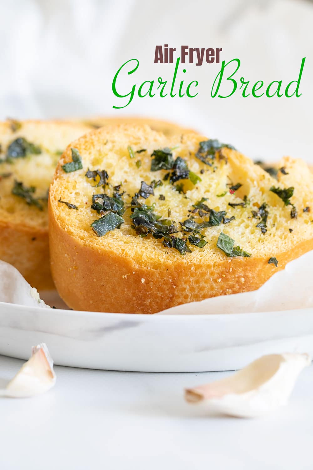 Side view of a slice of garlic bread on white plate.  Easy Thanksgiving Side Dishes