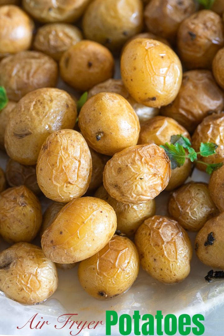 Closeup view of tiny potatoes in a garlic butter sauce put on a wax paper