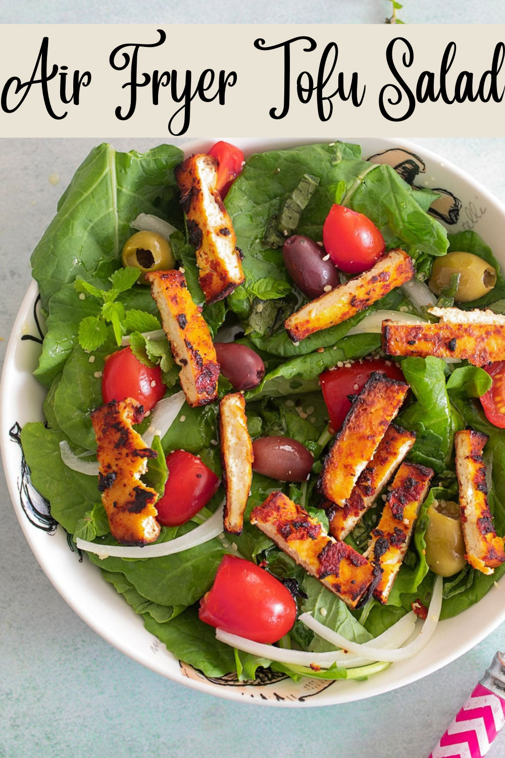 A bowl of tofu salad where the roasted tofu is cut into small, rectangle slices