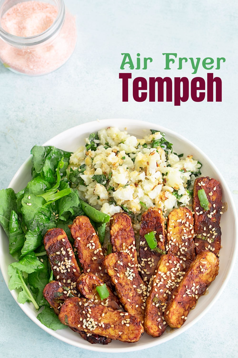 Top view of a vegan buddha bowl with air fryer tempeh, greens and rice. Easy healthy recipes