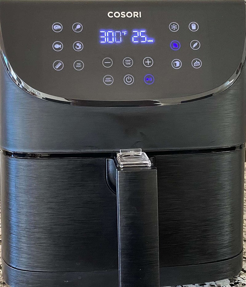 Front view of a COSORI Air fryer displaying the cook tempreture of 300°F and 25 Min Cook time