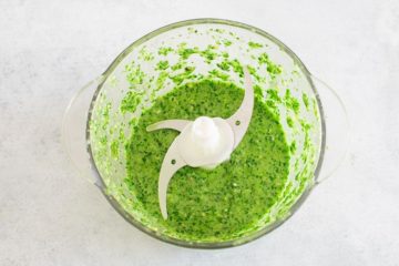 Top view of a blended scallion pesto sauce in the blender