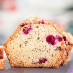 Front and closeup view of an upright slice of cranberry loaf cake