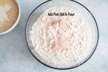 pink salt added to the flour in the glass bowl